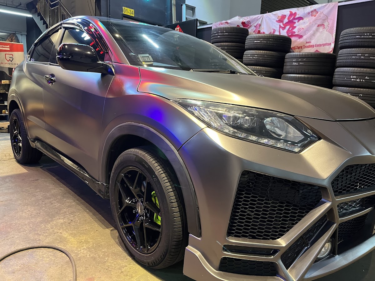 Matte grey wrapped crossover with black rims and green brake calipers