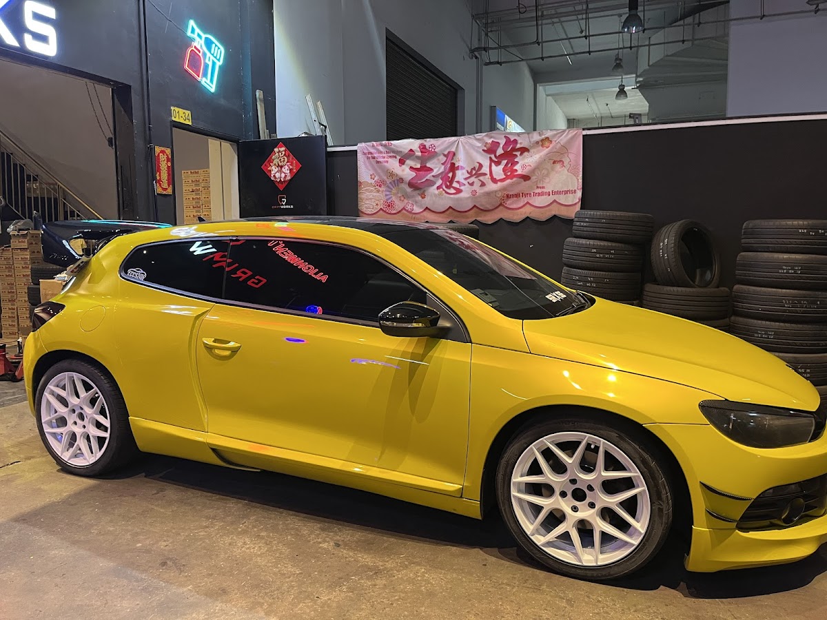 Gloss yellow Volkswagen Scirocco with freshly painted white rims at Grimworks