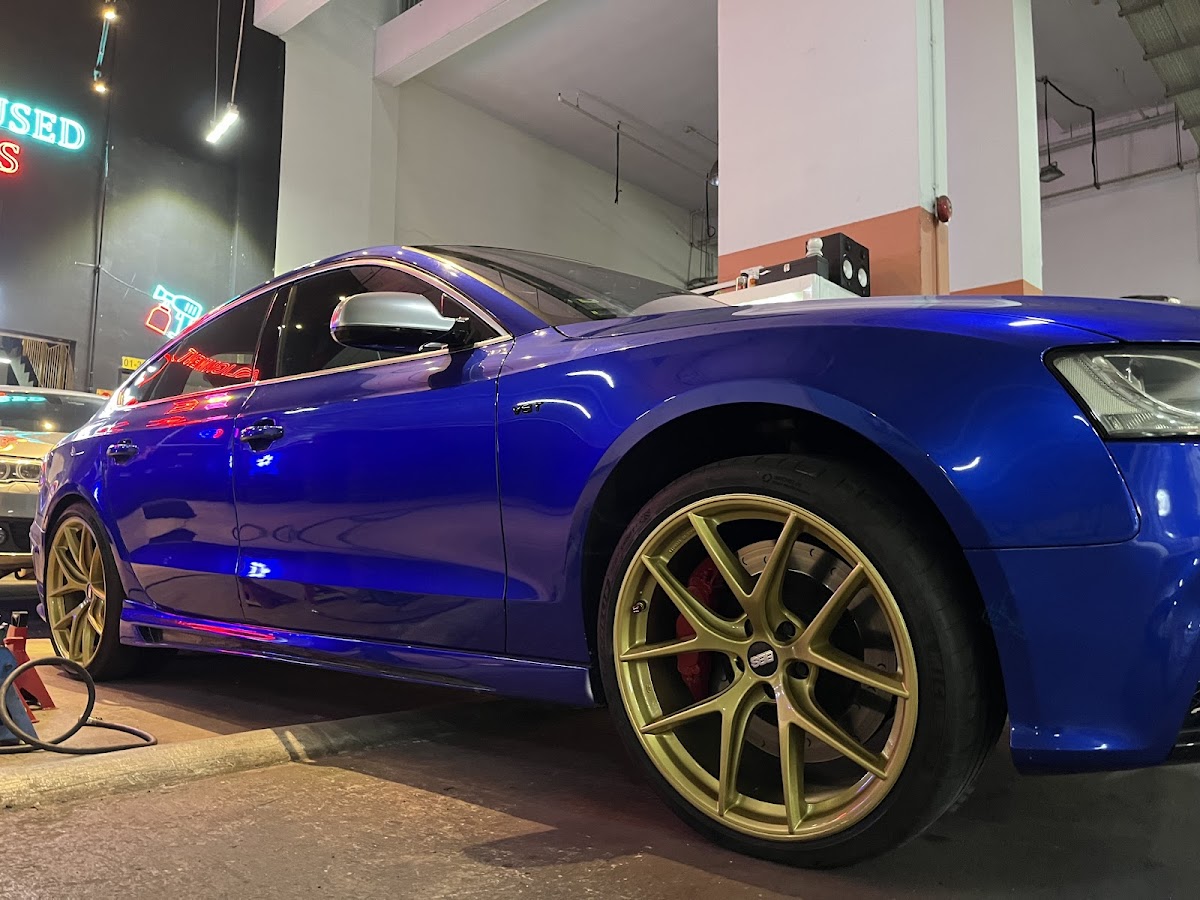 Blue Audi S5 with gold rims and red calipers, resprayed at Grimworks Yishun