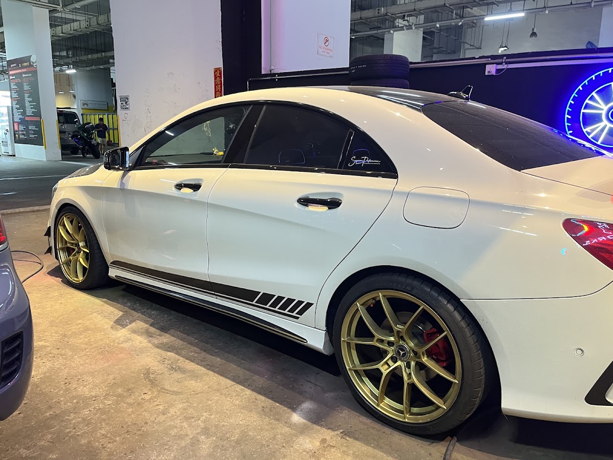 White Mercedes CLA with gold rims and red brake calipers
